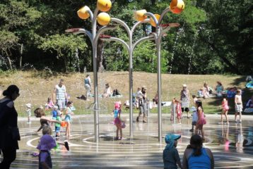 Spray park open with kids splashing around