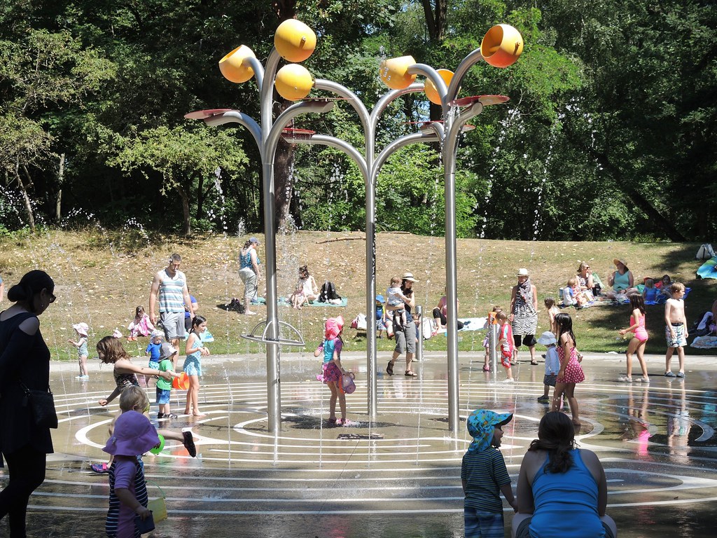 Spray park open with kids splashing around