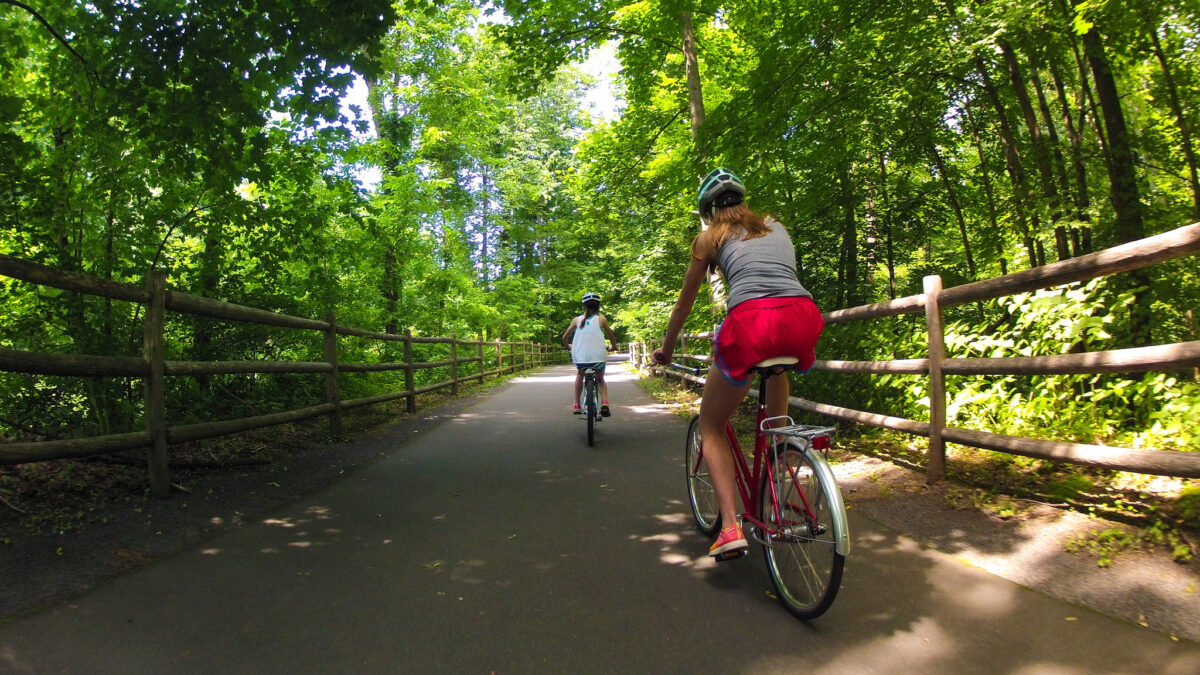 Child and parent biking on family-friendly trail near Seattle