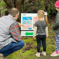 PopUp StoryWalk: Follow the trail to find the next page of a children's book.