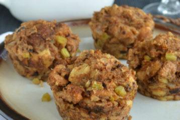 Individual Thanksgiving “stuffins” baked in a muffin tin, showing golden crispy edges and a mix of bread, pancetta, apples, and fennel.