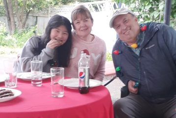family eating outside with Christmas decor