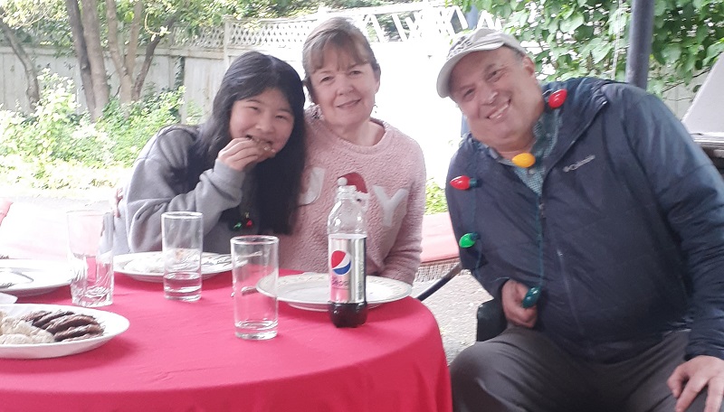 family eating outside with Christmas decor