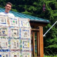 boy displaying handmade quilt