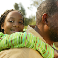 girl getting piggyback from dad
