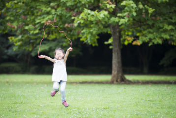 Picks. Girl jumping rope a park.