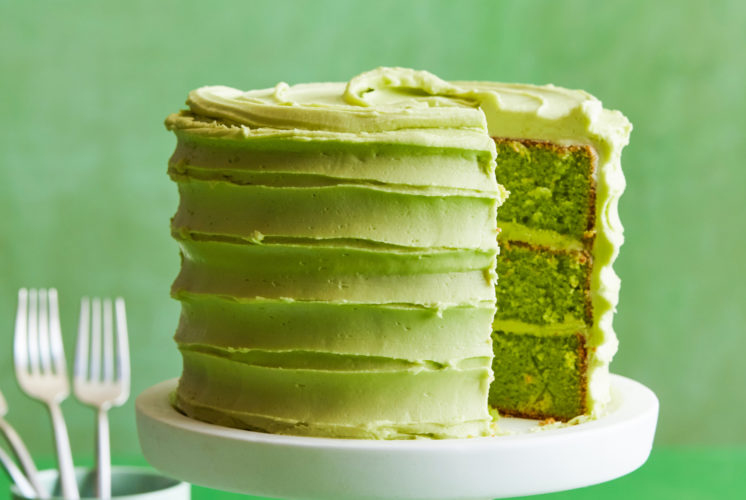 Green cake with slice missing