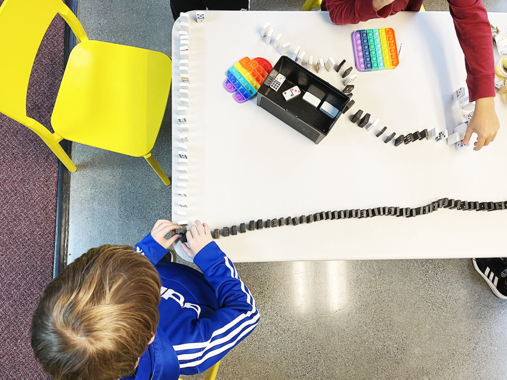 Morningside Academy student with dominoes