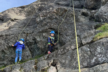 Two kids rock climbing