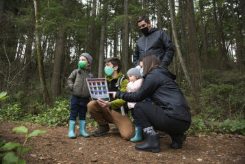 Family with a naturalist guide in the park