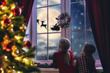 Illustration of kids looking out the window at Santa
