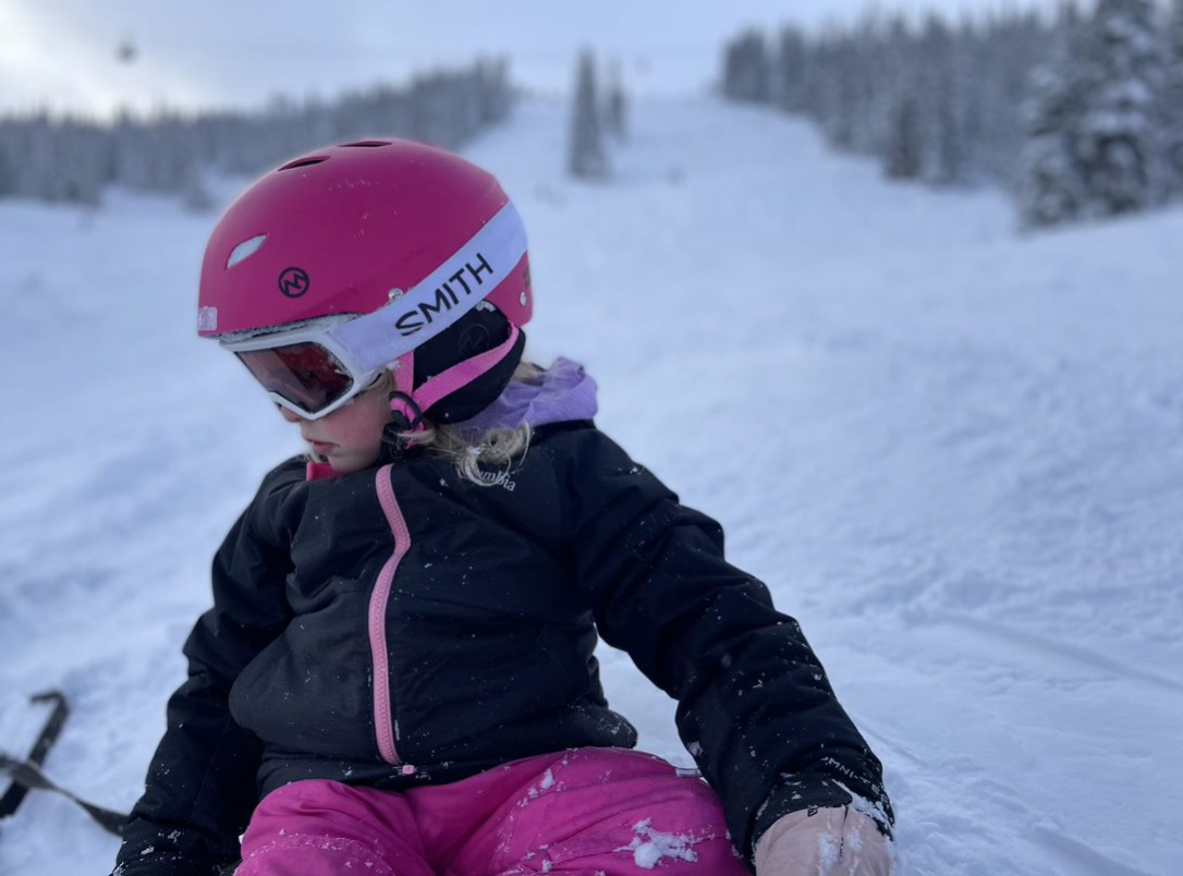 Sitting in the snow after a jaunt down the hill.
