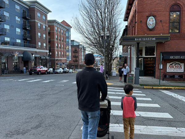 Family with kids and stroller walking through Fairhaven Historic District in Bellingham, Washington