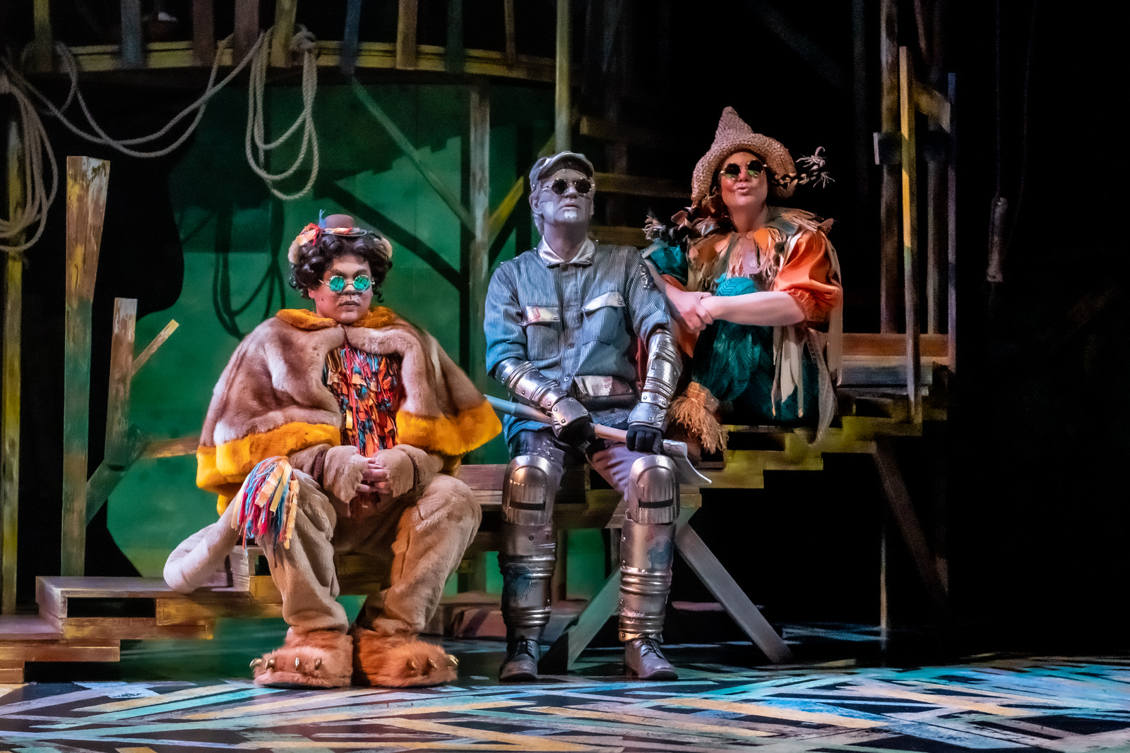 The lion Tin Man and Scarecrow sit with each other on the set of The Wonderful Wizard of Oz