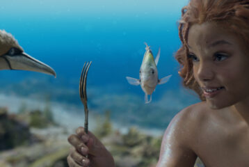 The Little Mermaid and her pals look at an unusual object - a fork