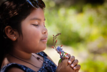 A girl practices mindfulness as she takes in the environment with all her senses