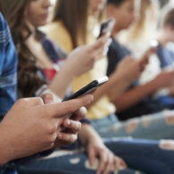 Teens using their phone to check social media which and advisory US Surgeon General Dr. Vivek Murthy days may be harmful to their health