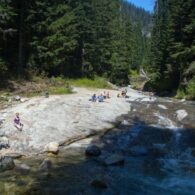 People sitting Denny Creek Natural Waterslides