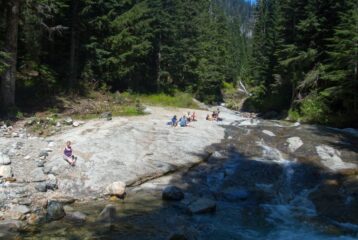 People sitting Denny Creek Natural Waterslides