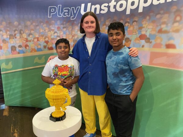 A LEGO Designer from Denmark posing with two boys