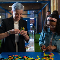 Soccer star Megan Rapinoe, left, and kid reporter Jazlyn 'Jazy' Guerra build LEGO bricks together after the LEGO Group's Play Unstoppable press conference on Friday, June 2, 2023 in Seattle. (Stephen Brashear/AP Images for The LEGO Group)