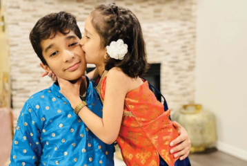 A family decorates their home with glowing diya lamps and marigold garlands for Diwali.