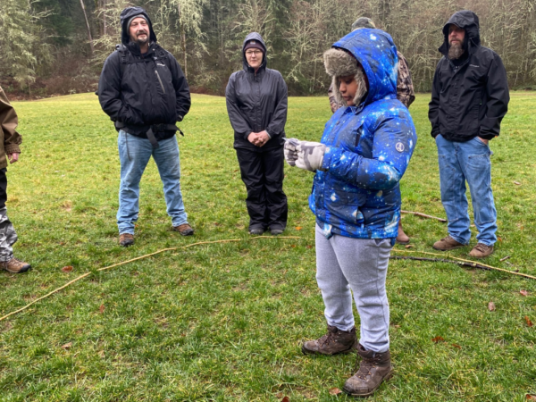 a child is reading a card about Big Leaf Maple trees