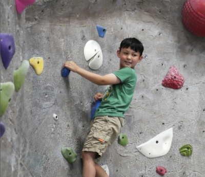Kid climbing on indoor rockkwall