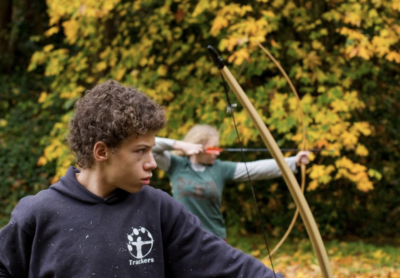 Kids shooting bow and arrows 
