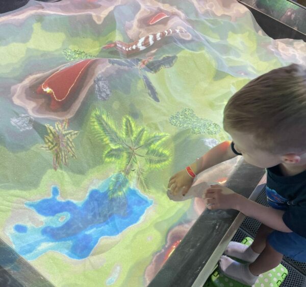 Kids play in colored sandbox