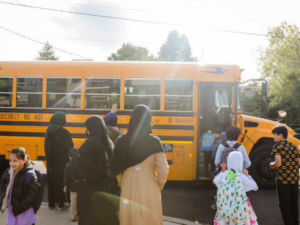 Refugees in schools waiting for bus