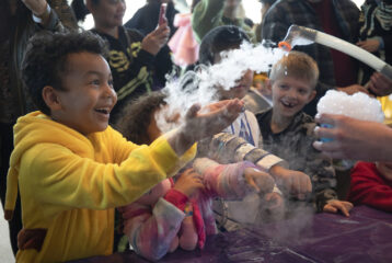 Child playing with Halloween-themed activities at the Museum of Fright in Seattle, a kid-friendly Halloween event.