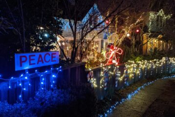 A view of Seattle’s Candy Cane Lane in the Ravenna neighborhood, glowing with holiday lights and decorated homes.