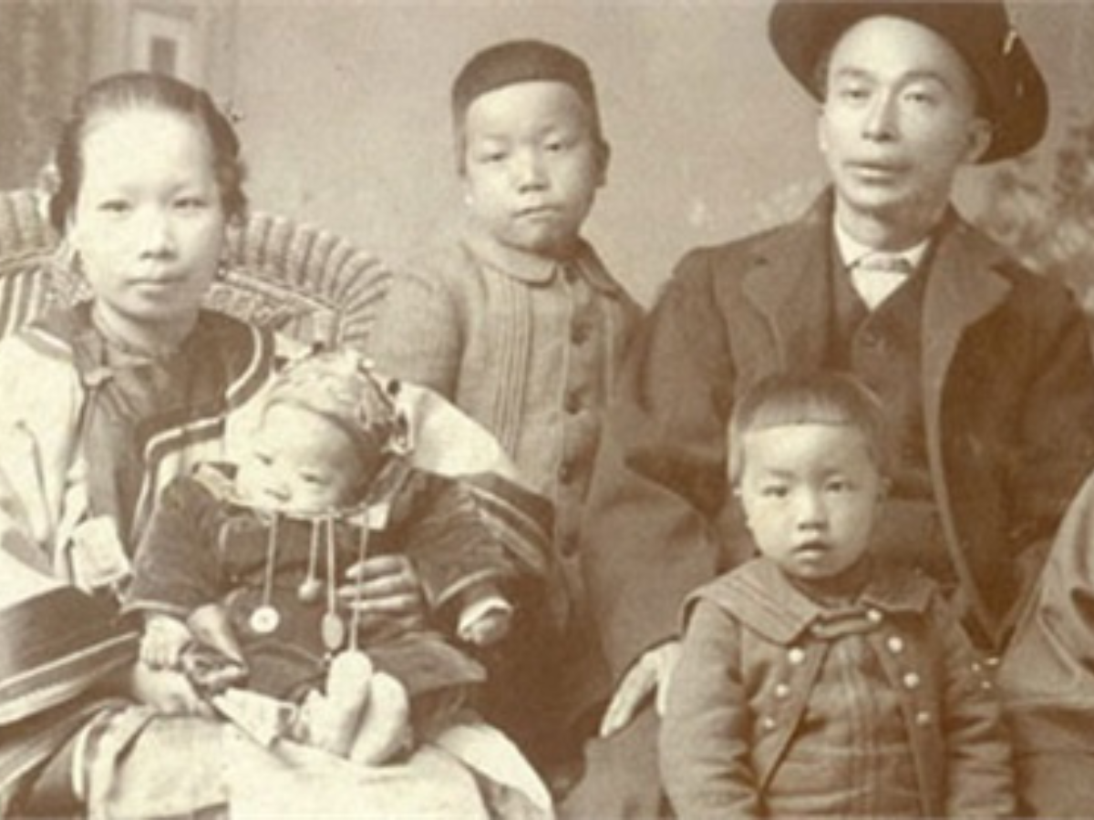 Historical photos of a Chinese family, showing mother holding small infant, and father standing next to two young children.