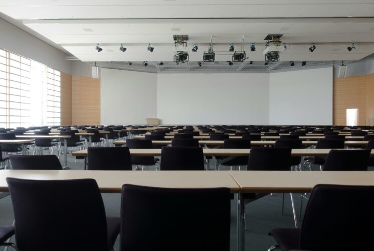 Empty chairs lined up in generic classroom