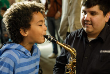 Child playing alto saxophone