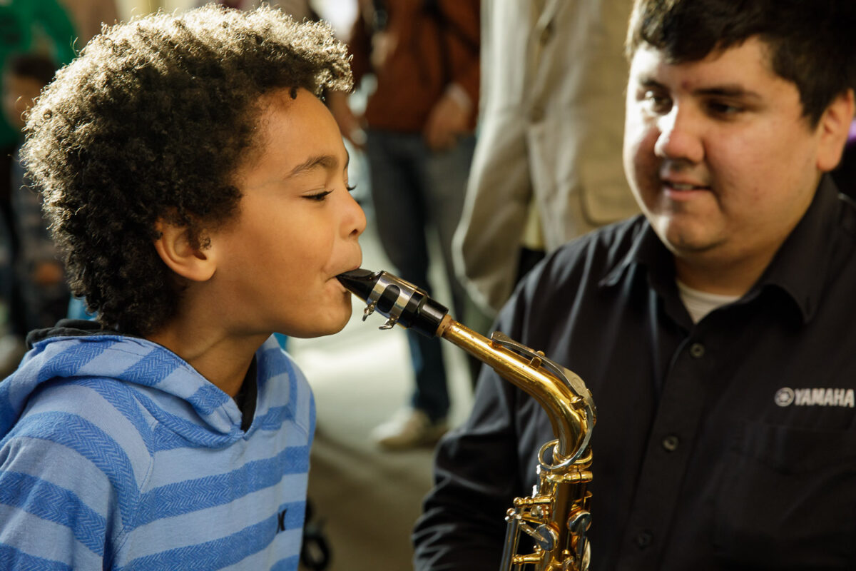 Child playing alto saxophone