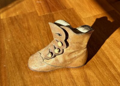 Worn old brown leather baby boot