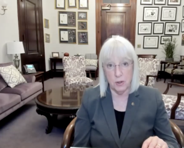 Patty Murray speak in a Zoom press conference, facing camera with office in background.