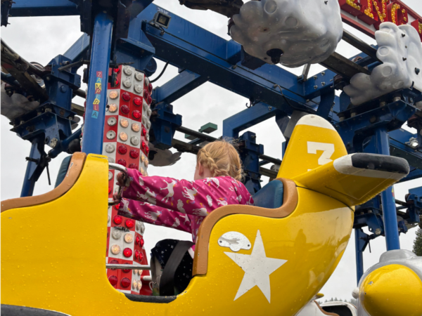 Kid sits in play airplane