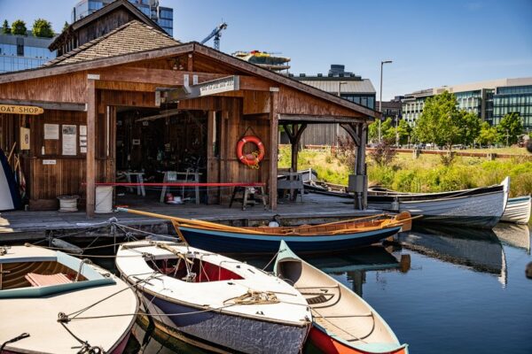 Rowboats docked besides a cute waterfront building