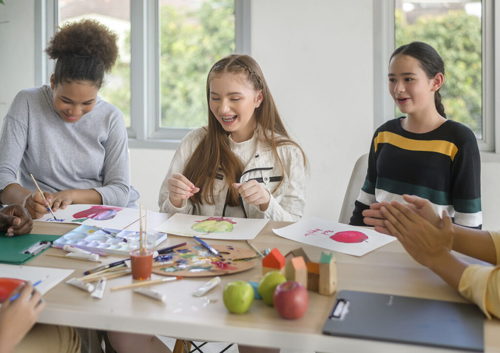 group of students studying and playing with teacher, education and learning concept.