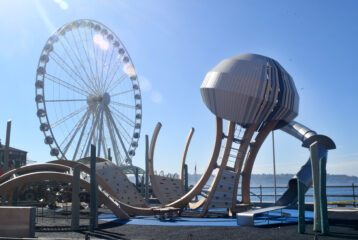Child climbing on jellyfish-inspired play structure at Seattle’s Pier 58 playground