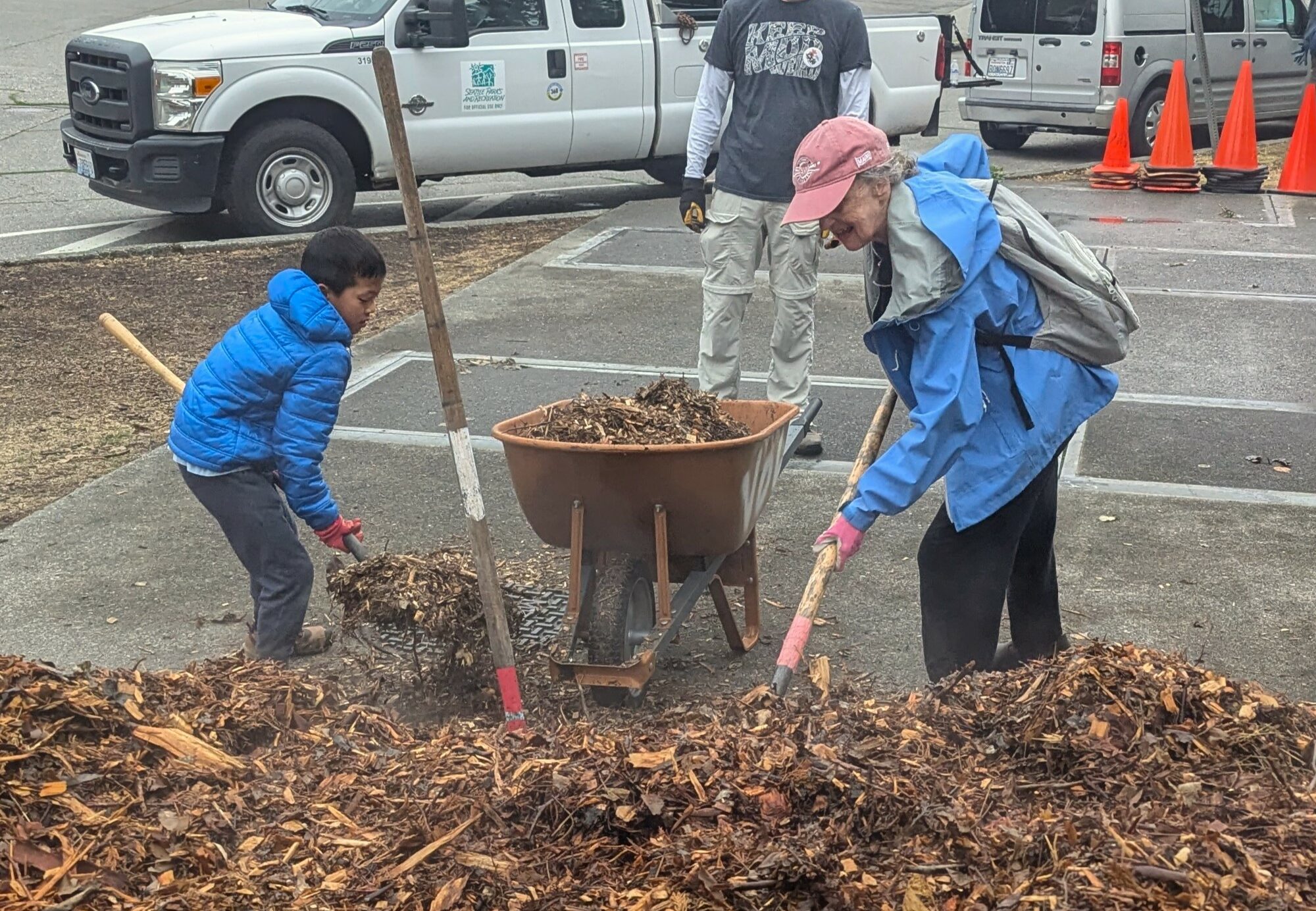 Kids and parents working together with shovels during Solid Ground’s Day of Service