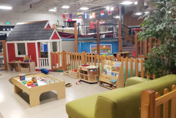 Main Street exhibits at the Children’s Museum of Skagit County in Burlington, featuring a tugboat, grocery store, and construction zone.