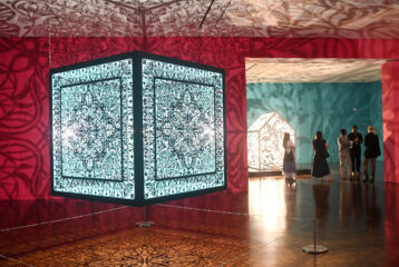 Illuminated sculptural installations casting intricate light and shadow designs.