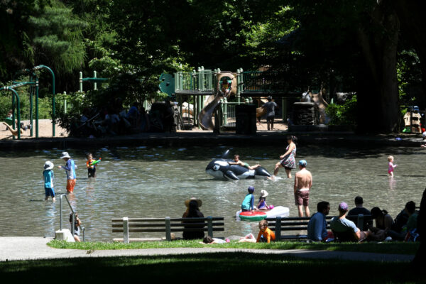 Children splashing in the large circular wading pool at Volunteer Park.