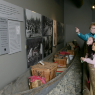 Children look at a historic caboose at the White River Valley Museum in Auburn, surrounded by interactive exhibits that bring local history to life.