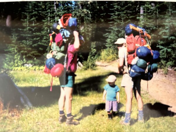 Childhood photo of author backpacking with family on a mountain trail