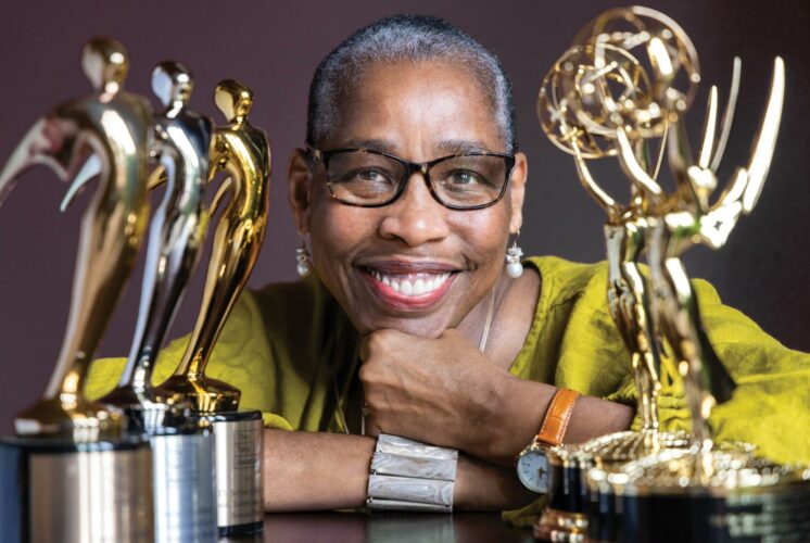 Val Thomas-Matson, producer and star of “Look, Listen and Learn,” smiling while holding Emmy and Telly Awards.